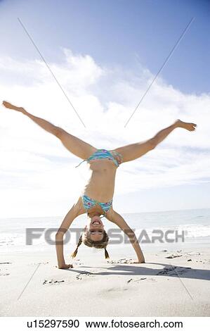 A young girl playing on the beach View Large Photo Image Stock Image - A young girl playing on the beach. Fotosearch