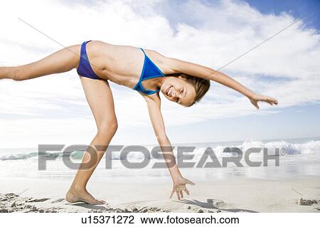 A young girl playing on the beach View Large Photo Image Stock Image - A young girl playing on the beach. Fotosearch