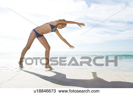 A young girl playing on the beach View Large Photo Image Stock Image - A young girl playing on the beach. Fotosearch