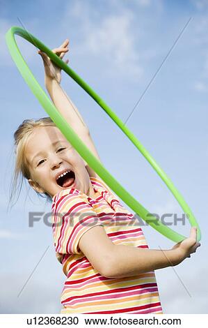 A young girl playing View Large Photo Image Stock Image - A young girl playing. Fotosearch