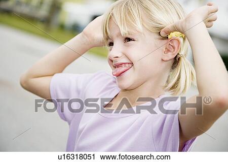 A young girl pulling a face View Large Photo Image Stock Image - A young girl pulling a face. Fotosearch