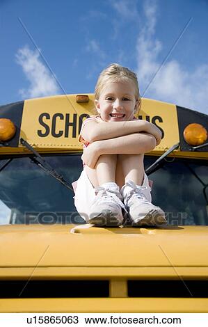 Stock Image - A young girl sitting on a school bus. Fotosearch