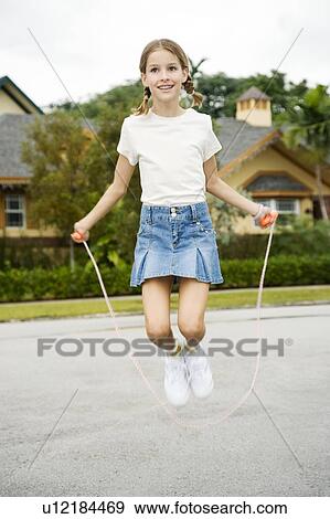 A young girl skipping View Large Photo Image Stock Photo - A young girl skipping. Fotosearch