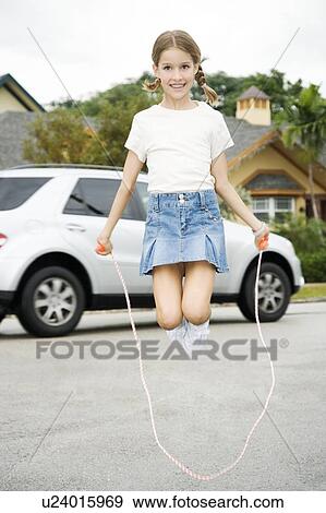 A young girl skipping View Large Photo Image Stock Photo - A young girl skipping. Fotosearch