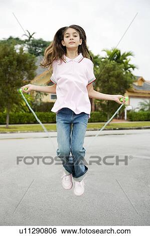 Stock Photograph - A young girl skipping. Fotosearch