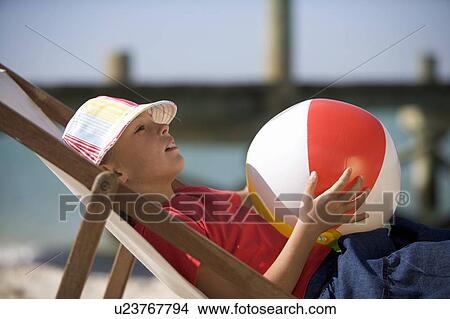A young girl with a beach ball View Large Photo Image Picture - A young girl with a beach ball. Fotosearch