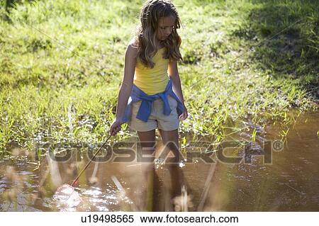 A young girl with a fishing net View Large Photo Image Stock Photography - A young girl with a fishing net. Fotosearch