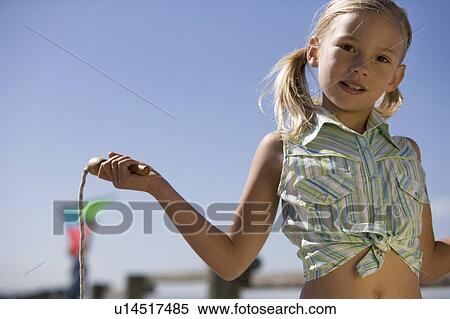 A young girl with a skipping rope View Large Photo Image Stock Photography - A young girl with a skipping rope. Fotosearch