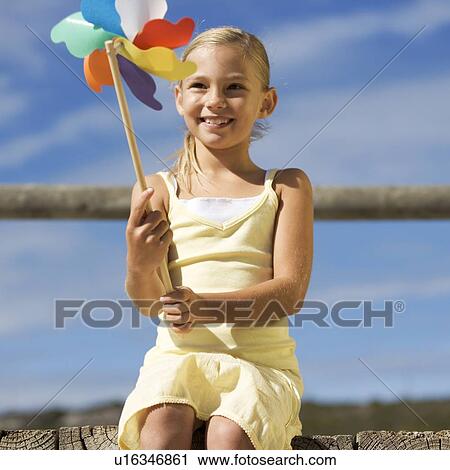 A young girl with a windmill View Large Photo Image Stock Image - A young girl with a windmill. Fotosearch