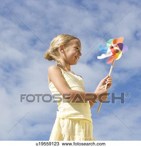 A young girl with a windmill View Large Photo Image Stock Image - A young girl with a windmill. Fotosearch