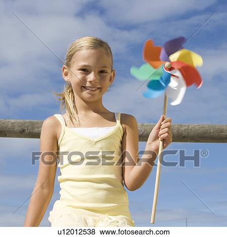 A young girl with a windmill View Large Photo Image Stock Photo - A young girl with a windmill. Fotosearch
