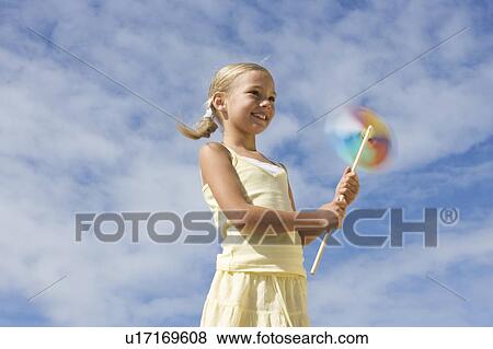Stock Photo - A young girl with a windmill. Fotosearch