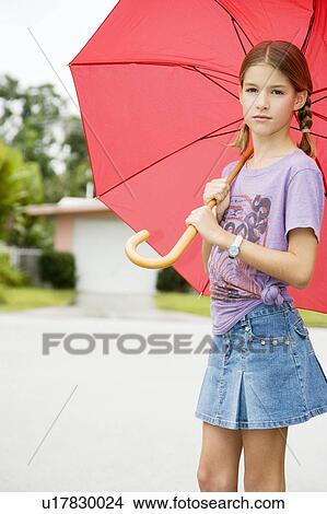 A young girl with an umbrella View Large Photo Image Picture - A young girl with an umbrella. Fotosearch