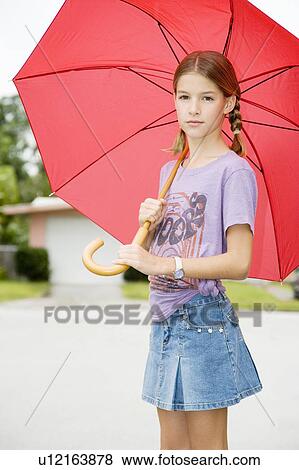 Stock Photo - A young girl with an umbrella. Fotosearch