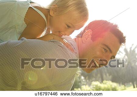 Stock Photograph - A young girl with her father. Fotosearch