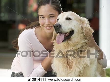 Stock Image - A young girl with her pet dog. Fotosearch