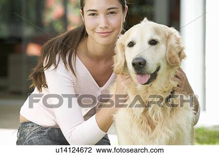 Stock Image - A young girl with her pet dog. Fotosearch