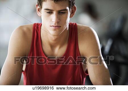 Stock Photograph - A young man at a gym. Fotosearch
