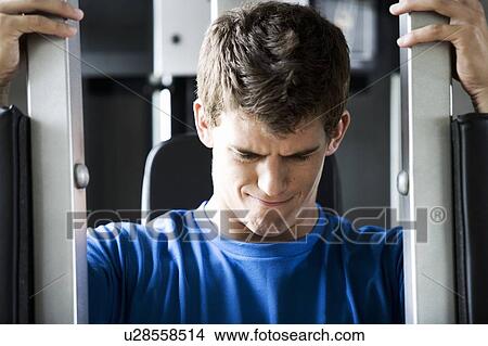 Picture - A young man exercising. Fotosearch