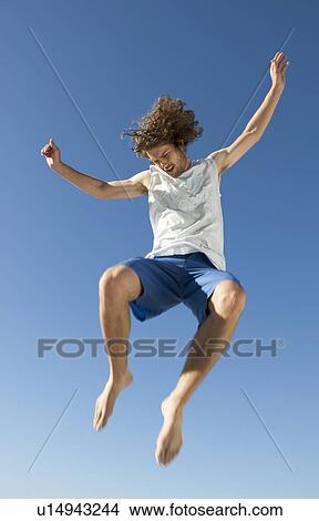 A young man jumping View Large Photo Image Picture - A young man jumping. Fotosearch