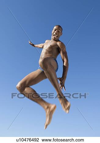 A young man jumping View Large Photo Image Stock Image - A young man jumping. Fotosearch