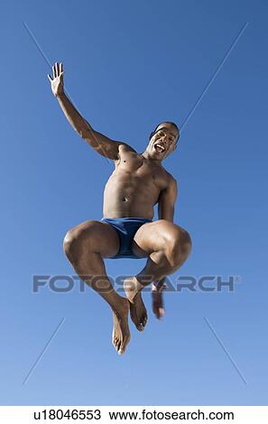 A young man jumping View Large Photo Image Stock Image - A young man jumping. Fotosearch