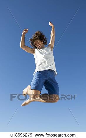 Stock Photo - A young man jumping. Fotosearch