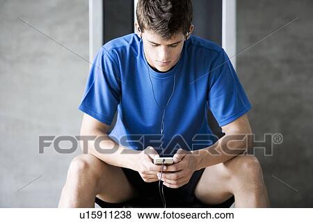 Stock Photo - A young man listening to music. Fotosearch
