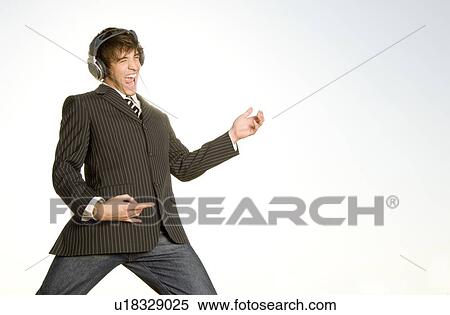 Stock Photography - A young man playing air guitar. Fotosearch