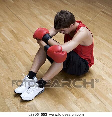 A young man wearing boxing gloves View Large Photo Image Stock Image - A young man wearing boxing gloves. Fotosearch
