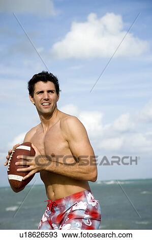 A young man with a ball on the beach View Large Photo Image Stock Image - A young man with a ball on the beach. Fotosearch