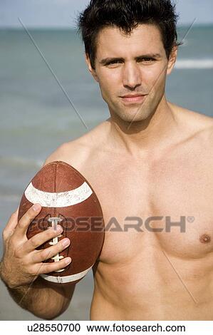 A young man with a ball on the beach View Large Photo Image Stock Image - A young man with a ball on the beach. Fotosearch