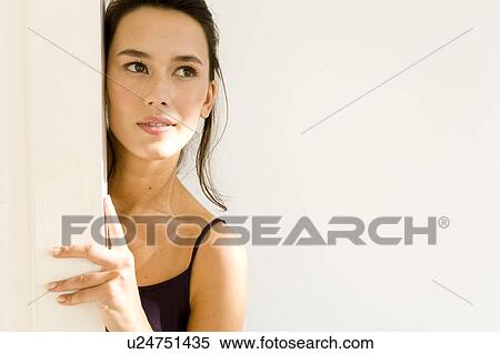 A young woman entering a room View Large Photo Image Stock Photography - A young woman entering a room. Fotosearch