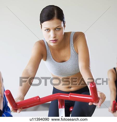 Stock Image - A young woman exercising. Fotosearch