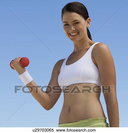 Stock Photography - A young woman exercising. Fotosearch
