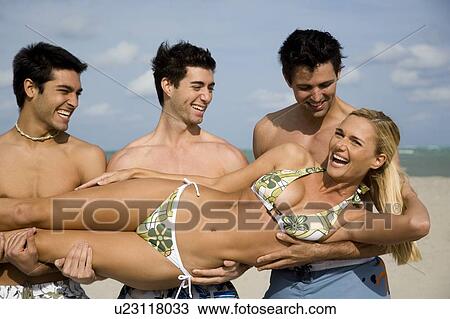 A young woman in a bikini with three male admirers View Large Photo Image Stock Image - A young woman in a bikini with three male admirers. Fotosearch