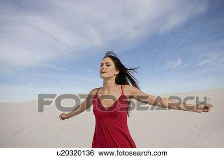 Stock Photograph - A young woman in a red dress. Fotosearch