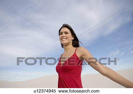 A young woman in a red dress View Large Photo Image Stock Photography - A young woman in a red dress. Fotosearch