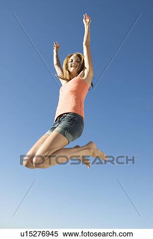 A young woman jumping View Large Photo Image Stock Photography - A young woman jumping. Fotosearch