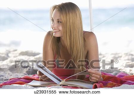 A young woman laying on a beach View Large Photo Image Stock Photography - A young woman laying on a beach. Fotosearch