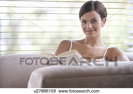 A young woman reading View Large Photo Image Stock Photo - A young woman reading. Fotosearch