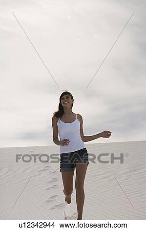 A young woman running in the desert View Large Photo Image Picture - A young woman running in the desert. Fotosearch