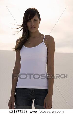 A young woman standing in the desert View Large Photo Image Stock Photo - A young woman standing in the desert. Fotosearch