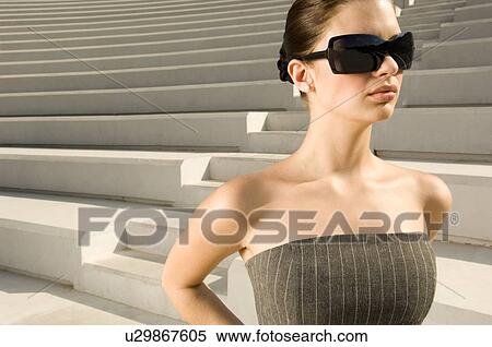 Stock Photography - A young woman standing on steps. Fotosearch