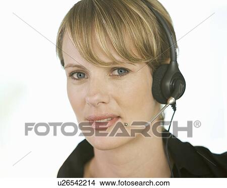 A young woman wearing an audio headset View Large Photo Image Picture - A young woman wearing an audio headset. Fotosearch