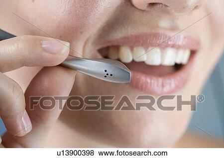 A young woman wearing an audio headset View Large Photo Image Stock Photo - A young woman wearing an audio headset. Fotosearch