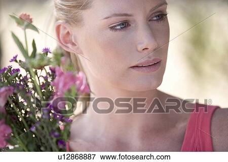 A young woman with a bouquet of flowers, close-up View Large Photo Image Stock Photo - A young woman with a bouquet of flowers, close-up. Fotosearch