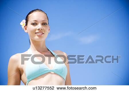 A young woman with flower in hair View Large Photo Image Stock Image - A young woman with flower in hair . Fotosearch