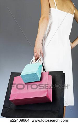 A young woman with shopping bags View Large Photo Image Picture - A young woman with shopping bags. Fotosearch