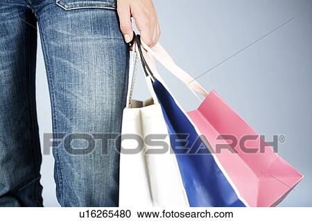 A young woman with shopping bags View Large Photo Image Stock Image - A young woman with shopping bags. Fotosearch